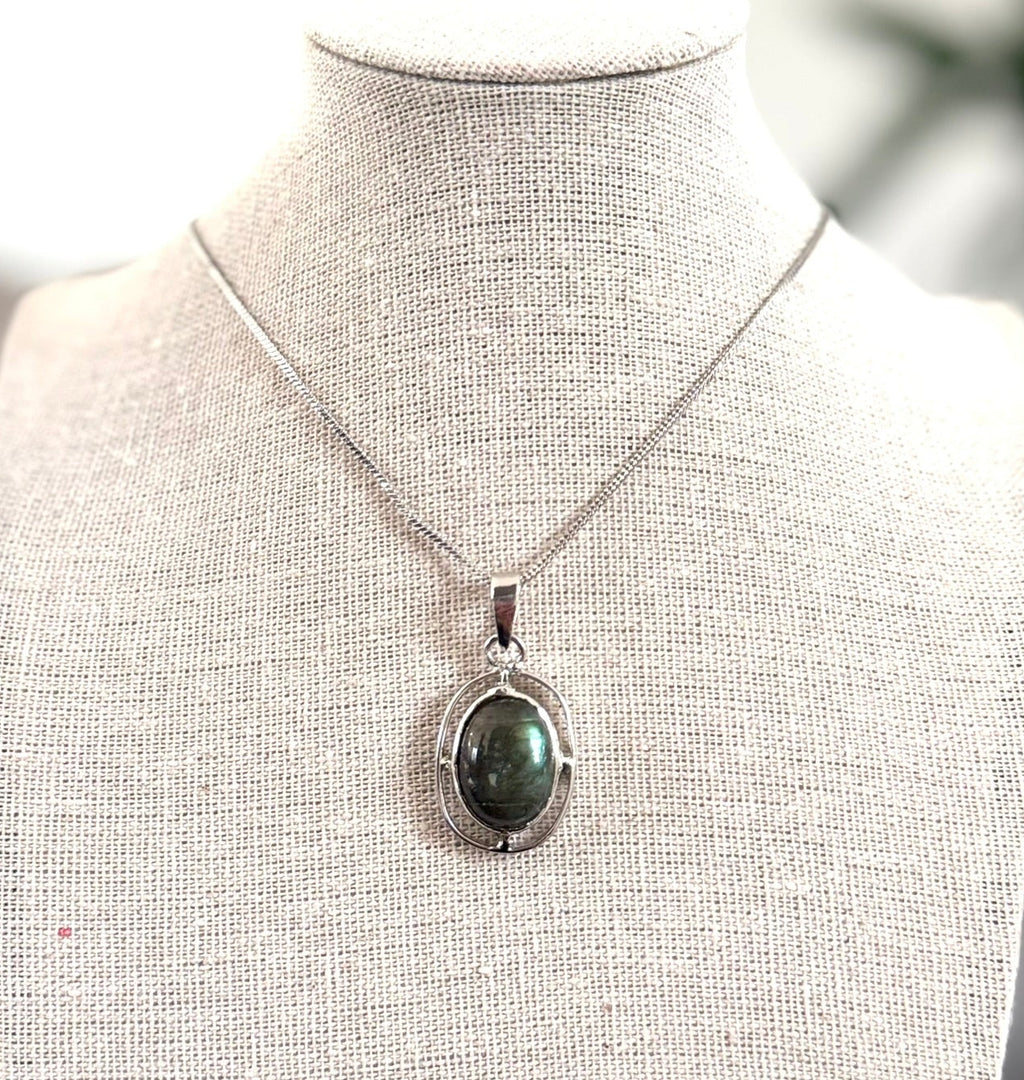 Necklace with a pendant on a mannequin bust against a blurred background