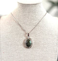 Necklace with a pendant on a mannequin bust against a blurred background