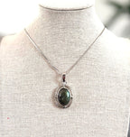 Necklace with a pendant on a mannequin bust against a blurred background